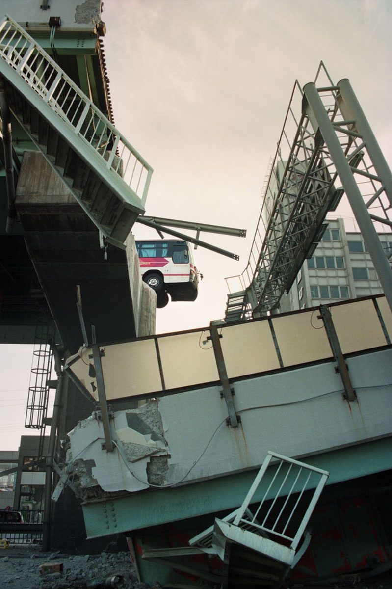 A tour bus hanging at the edge of the collapsed Hanshin Expressway